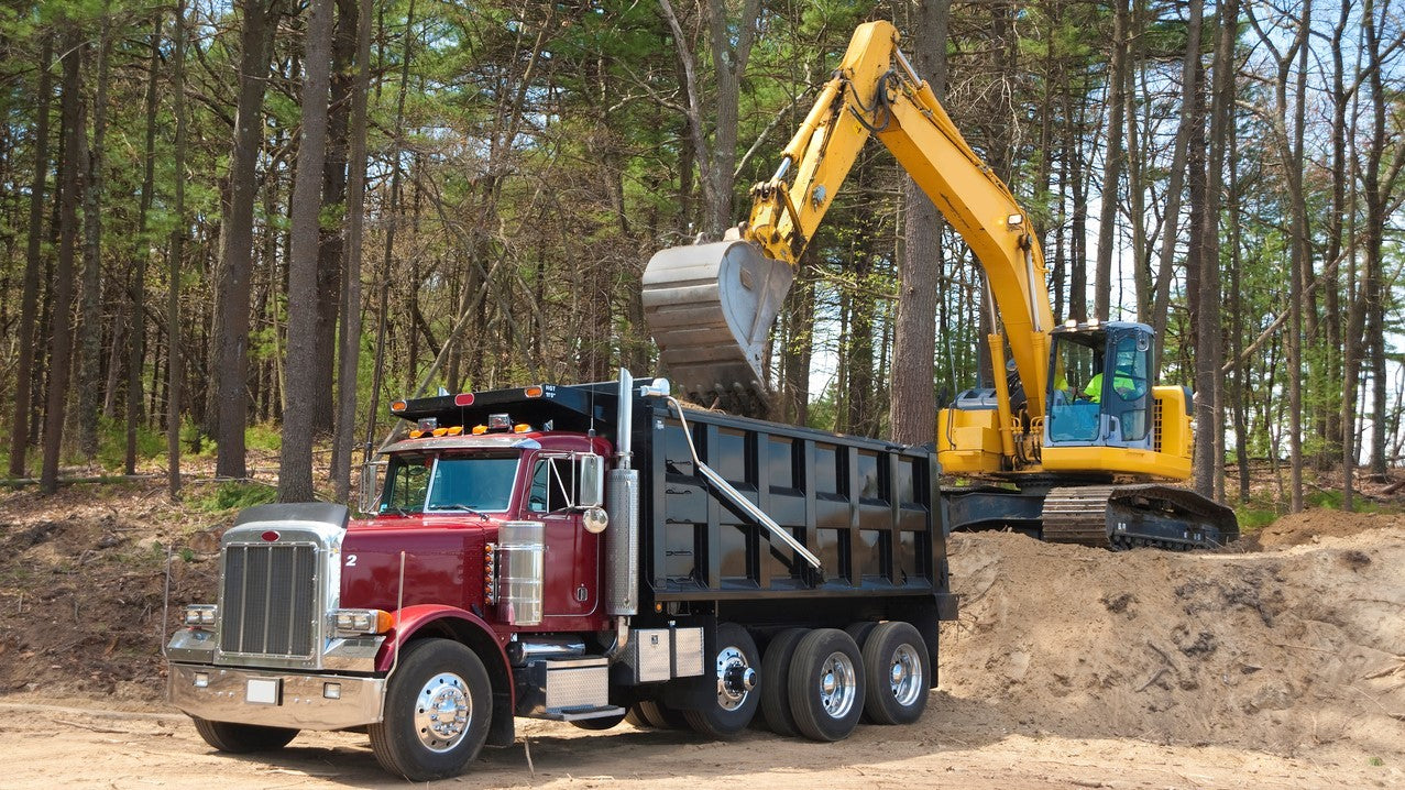Dump Truck getting Loaded by Excavator